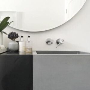 Modern grey bathroom sink with sleek wall-mounted tap and minimalist decor, showcasing contemporary bathroom fixtures from Bathroom Store.