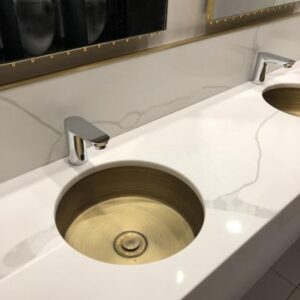 Sleek modern bathroom vanity with double gold sinks and contemporary chrome faucets, perfect for luxurious bathroom renovations and elegant washroom designs in South Africa.