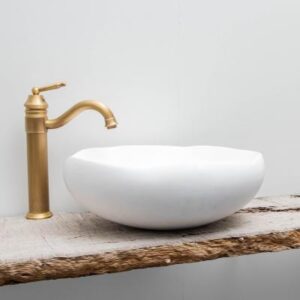 Elegant white stone vessel sink with a brushed gold faucet, perfect for modern bathrooms in South Africa. Stylish, durable, and easy to clean for a sophisticated bathroom upgrade.