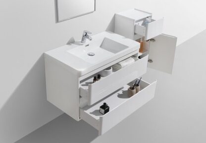 Modern white bathroom vanity with integrated sink, storage drawers, and open shelving for bathroom accessories. Perfect for contemporary bathroom décor and organization.