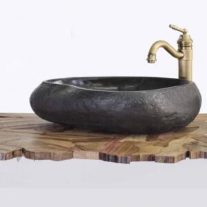 Elegant black stone bathroom sink with brass faucet, perfect for luxury bathroom designs, natural stone finish, durable and stylish bathroom basin for modern spaces.