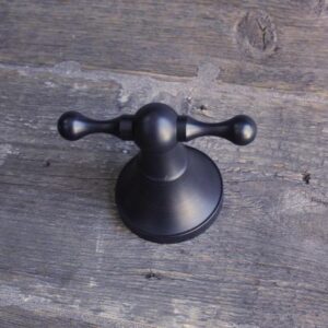 Elegant black showerhead holder for bathroom accessories, crafted for durability and style. Perfect for modern bathroom renovation and optimising space.