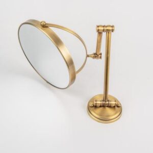 Elegant gold-framed magnifying mirror for bathroom decor, featuring a sleek adjustable stand. Perfect for stylish and functional bathroom accessories.